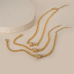 Close-up of golden Cuban link chain featuring marquise-cut zircon leaf-shaped accents