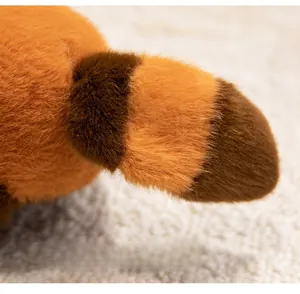 Close-up of the soft plush tail with orange and brown stripes and fluffy fiber texture