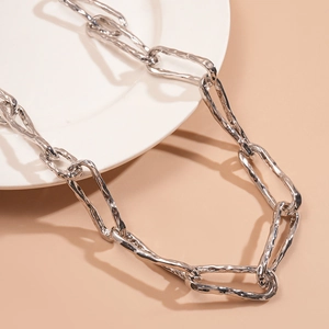 Detailed view of silver chunky link necklace with irregular textured metal design