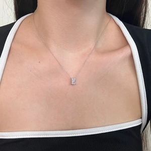 Detailed view of an S925 silver necklace featuring a geometric ice-cut pendant on a model
