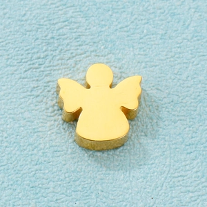 Macro shot of a golden metal angel locket pendant on a blue textured surface