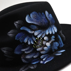 Black wool fedora hat featuring hand-painted blue floral patterns and gold glitter accents