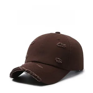 Detailed close-up of distressed soft-top baseball cap with vintage frayed brim details