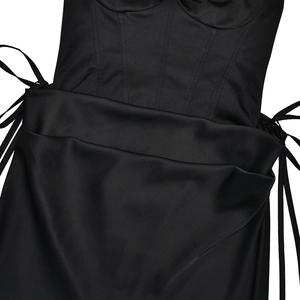 Detailed close-up of side drawstring lacing and stitched waist on black slim fit dress