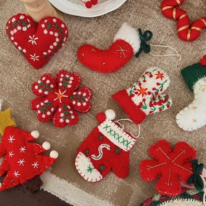 Handmade wool felt Christmas ornaments with heart, snowflake, and stocking shapes