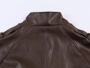Detailed view of the dark brown faux leather jacket collar and shoulder stitching