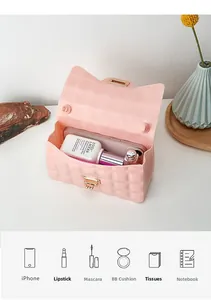 Pink diamond lattice jelly bag with cat ear flap and golden turn lock showing interior capacity