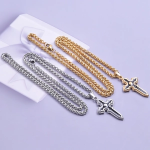 Detail of silver and gold cross sword pendants with thick wheat chain on purple background