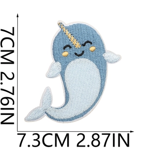Detail view of narwhal embroidery patch with precise measurement markings on white background