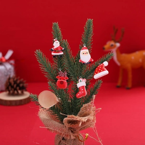 Christmas resin charm set with Santa, reindeer, and stockings on miniature pine tree
