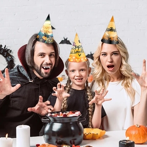 Three Halloween paper hats with pumpkin and castle designs for family party celebration