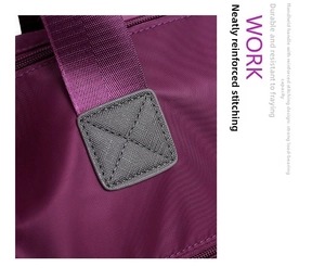 Detail of reinforced bartack stitching on durable purple oxford fabric handbag