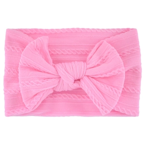 Close-up of pink cable knit baby headband with a large decorative soft bow detail