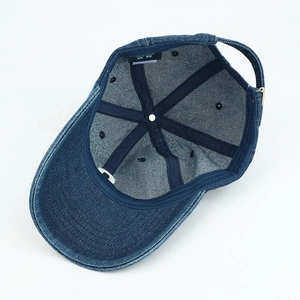 Detail of blue denim baseball cap interior showing metal buckle and brand label