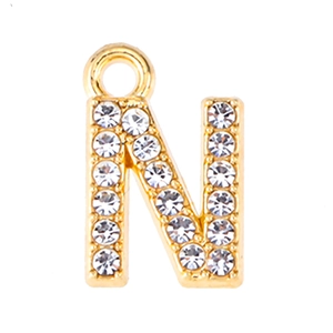 Close-up of gold alloy letter N pendant with sparkling rhinestones for DIY jewelry