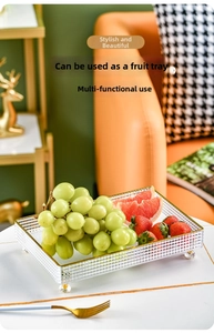 Detail of luxury fruit tray with gold trim and crystal feet holding fresh fruits