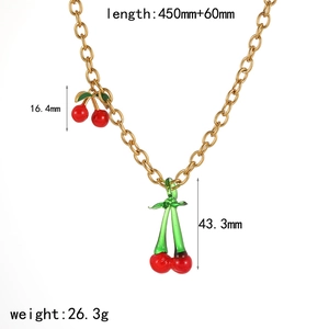 Detail view of gold chain necklace featuring red cherry pendants and size measurements