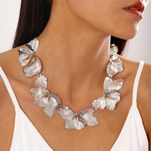 Close-up of metallic textured petal choker necklace in silver finish on model's neck