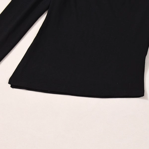 Detail of black long sleeve top showing precise stitching and soft knit fabric texture