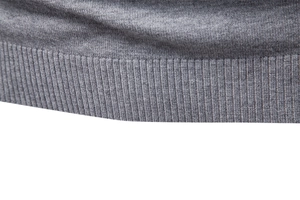 Detail of grey ribbed hem and fine knit texture on a men's winter turtleneck sweater