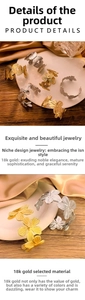 Close-up of 18K gold plated butterfly and flower open cuff bracelet with hollow details