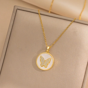 Gold butterfly pendant necklace with shimmering zircons and mother of pearl inlay