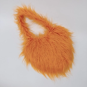 Detailed top view of a bright orange fluffy faux fur heart-shaped crossbody shoulder bag