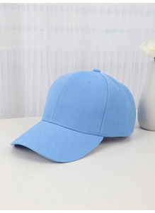 Detail of light blue cotton baseball cap on a clean tabletop with floral background