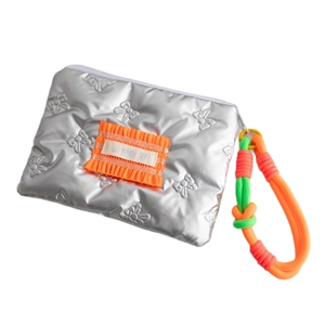 Silver quilted PU makeup bag with orange accent and colorful woven rope handle