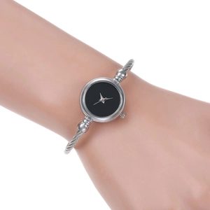 Elegant silver bangle watch for women with minimalist black dial worn on wrist