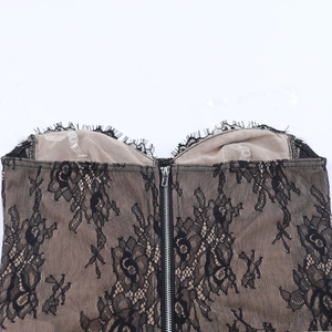 Detail of floral lace corset top with silver front zipper and sheer beige mesh lining