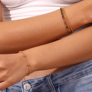 Detailed close-up of double-sided flower bracelet in 18K gold plated stainless steel