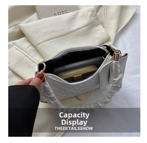 Internal capacity of quilted handbag showing space for a smartphone and wallet