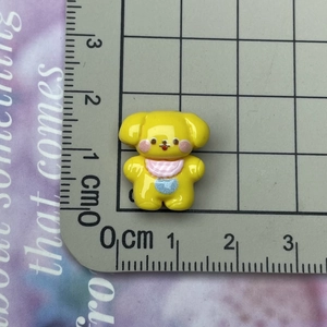 Miniature yellow resin puppy DIY charm for hair clips and phone cases on scale mat
