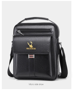 Side view of black business shoulder bag showing textured leather and zipper pockets