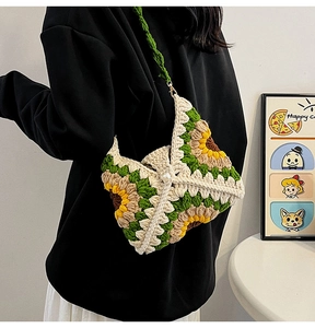Detail of sunflower crochet bag with green woven strap and elegant pearl button closure
