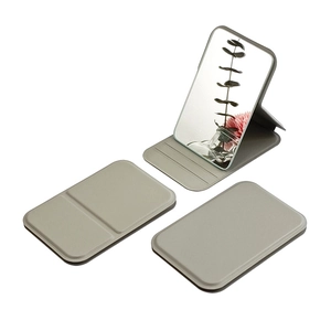 Portable gray folding vanity mirror with rectangular faux leather cover and stand
