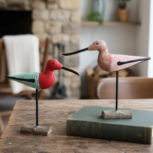 Nordic hand-painted wooden bird ornaments on metal stands and raw wood bases