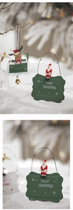 Close-up of Merry Christmas iron signs with Santa and reindeer on festive background