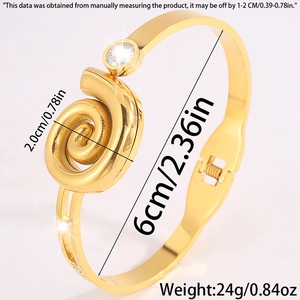 Detail view of gold spiral bangle with crystal accents and 6cm inner diameter sizing