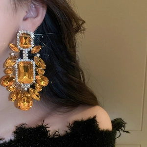 Close-up of elegant amber drop earrings with sparkling rhinestones for evening wear