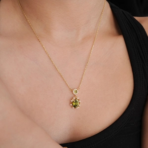18K gold plated necklace with oval olive green gemstone and zircon on a model