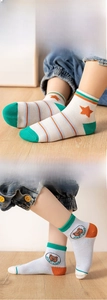 Detail of kids mesh cotton socks featuring cute astronaut bear and orange star patterns