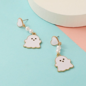 Detail view of white ghost earrings with golden heart studs and elegant pearls on colorful background