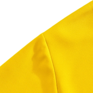 Close-up of bright yellow polo shirt featuring breathable pique cotton mesh fabric