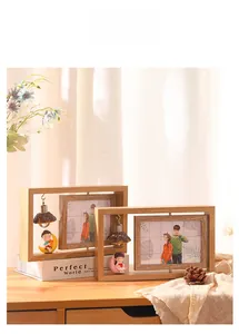 Detail of creative double-sided rotating wooden photo frame with a warm lightbulb decoration