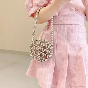Handmade silver beaded crossbody bag with acrylic pearls on pink dress model