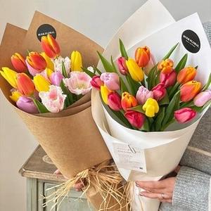 Close-up of wavy ripple pleated gauze wrapping paper on vibrant tulip bouquets