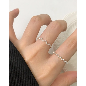 Minimalist S925 sterling silver twisted wave and beaded stackable rings on female finger