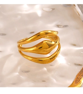 Macro shot of gold layered wavy ring with polished finish and modern flowing lines
